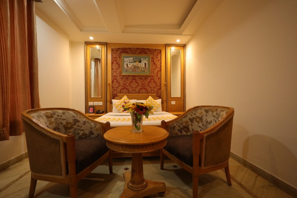 Elegant hotel room with seating area and decor